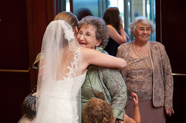 the bride hugging guests - photo by Houston based wedding photographer Adam Nyholt